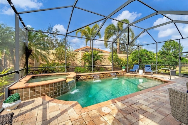 view of pool featuring a patio, a lanai, pool water feature, and an in ground hot tub