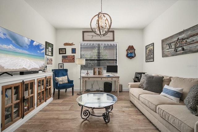 living room featuring a notable chandelier and light wood-type flooring