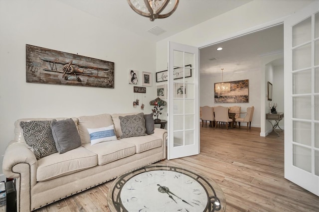 living room with french doors and hardwood / wood-style flooring