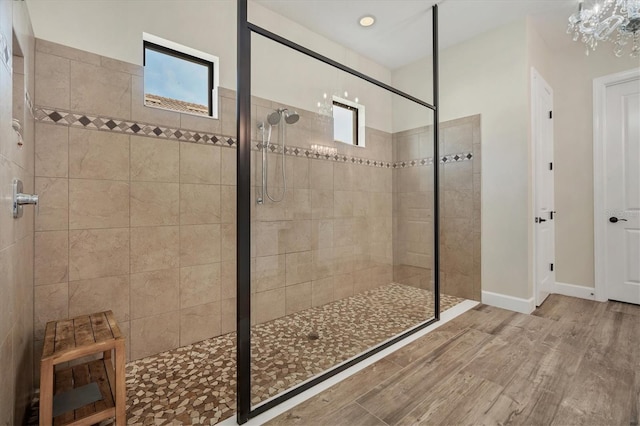 bathroom featuring a tile shower and hardwood / wood-style flooring