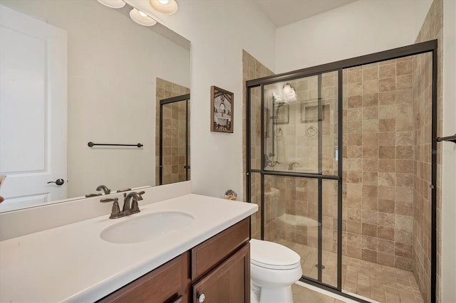 bathroom featuring vanity, toilet, and walk in shower