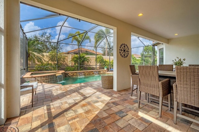 view of pool with pool water feature, an in ground hot tub, a patio area, and glass enclosure