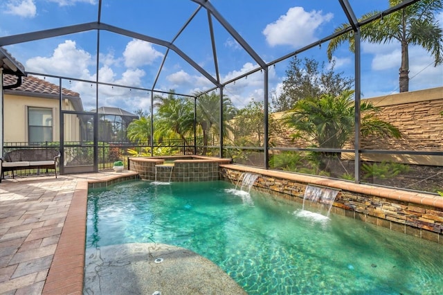 view of pool with an in ground hot tub, pool water feature, a patio, and a lanai