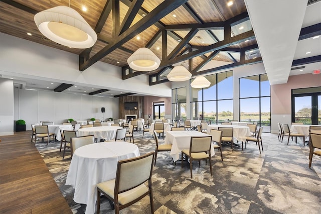 dining area featuring beamed ceiling, high vaulted ceiling, and wooden ceiling