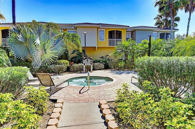 view of pool featuring an in ground hot tub and a patio area