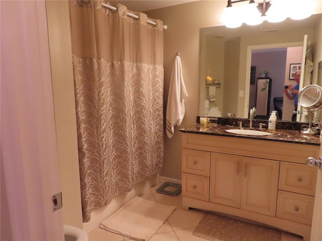 bathroom featuring tile patterned flooring, vanity, and a shower with curtain