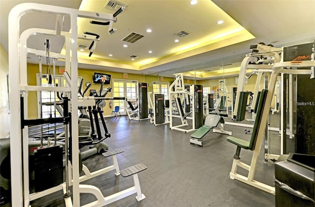 workout area featuring a tray ceiling