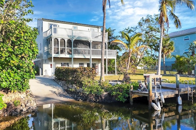 rear view of property featuring a balcony and a water view