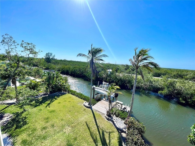 water view featuring a dock and a lawn