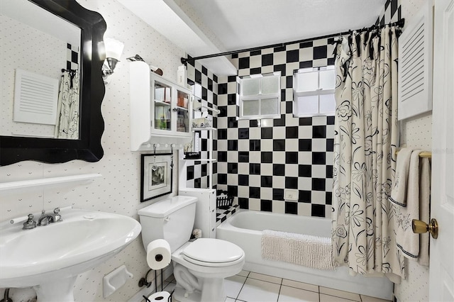 full bathroom with tile patterned flooring, sink, shower / tub combo, and toilet