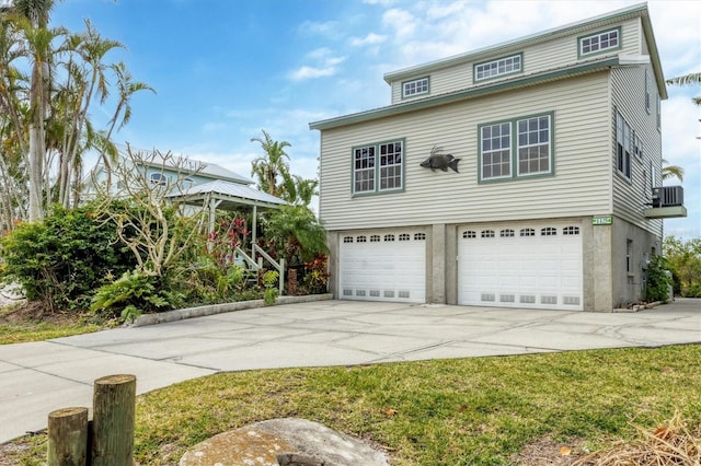 view of front of house featuring a garage and central air condition unit