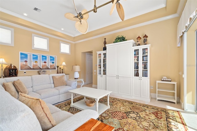 living room featuring crown molding, tile patterned floors, and a raised ceiling