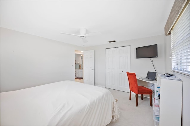 carpeted bedroom featuring ceiling fan and a closet