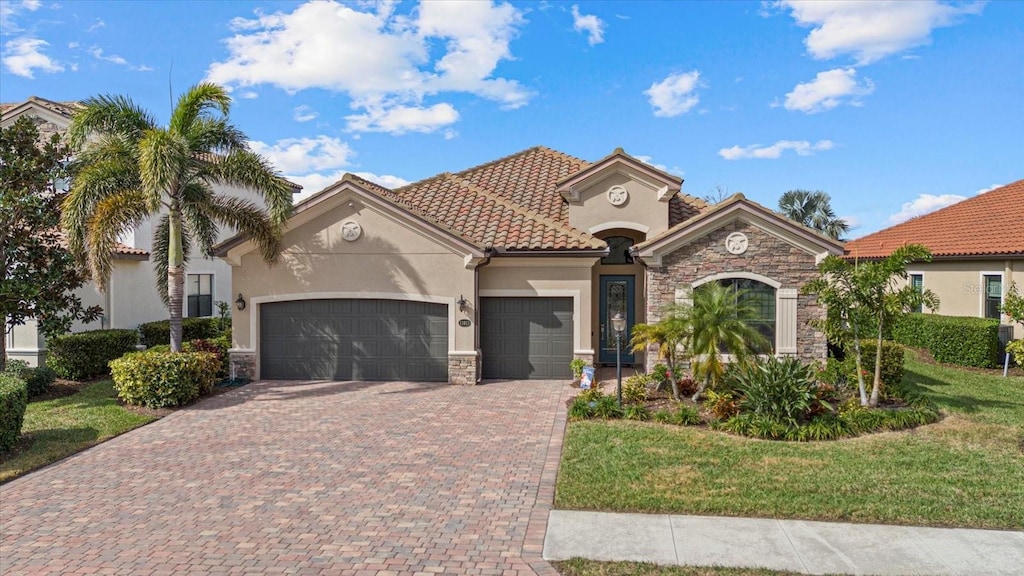 mediterranean / spanish-style house with a garage and a front yard