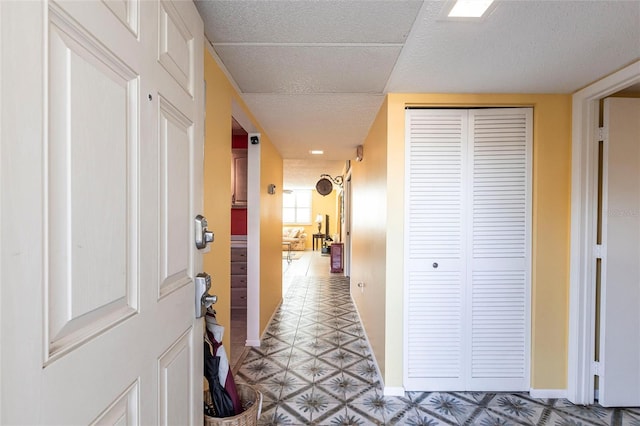 hall with a textured ceiling