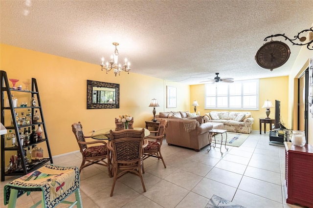 dining room with light tile patterned floors, ceiling fan with notable chandelier, and a textured ceiling