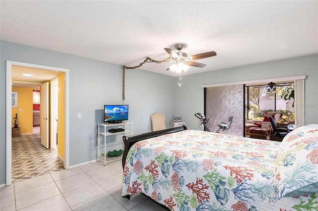 bedroom featuring access to exterior, light tile patterned floors, a textured ceiling, and ceiling fan