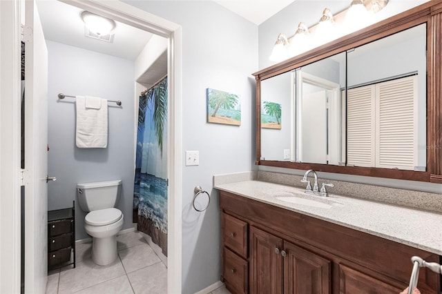 bathroom featuring tile patterned flooring, vanity, a shower with curtain, and toilet