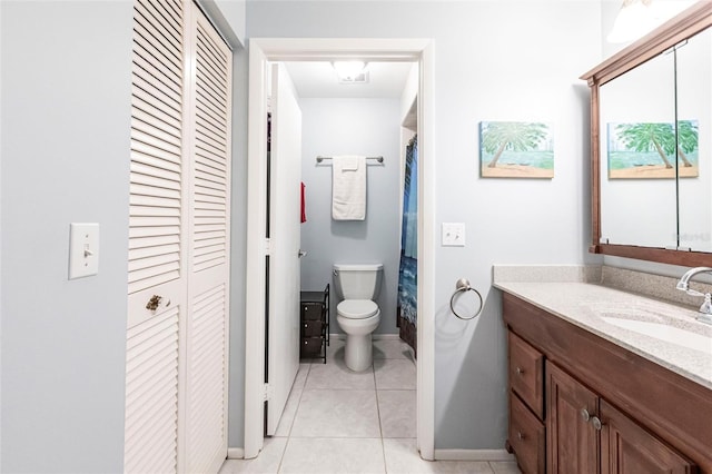 bathroom with vanity, tile patterned floors, and toilet