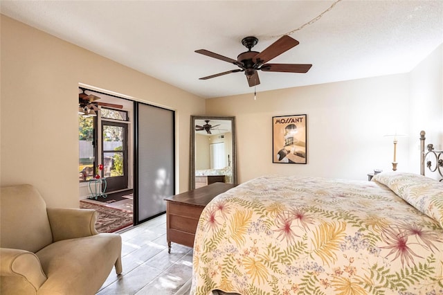 tiled bedroom featuring access to outside and ceiling fan