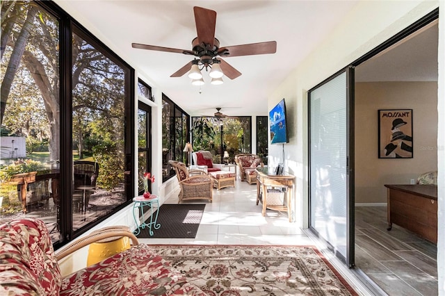 sunroom featuring ceiling fan