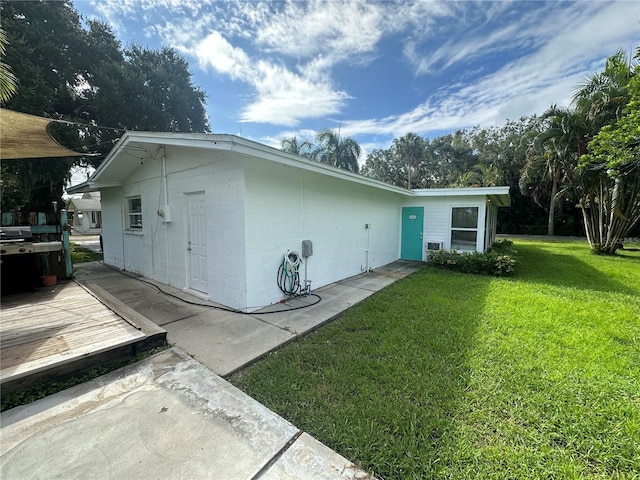 rear view of house featuring a yard