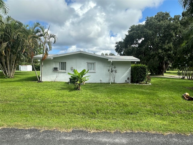 view of side of home featuring a lawn