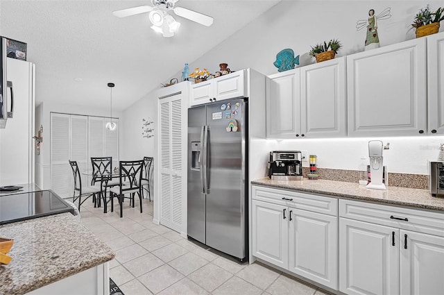 kitchen with stainless steel fridge with ice dispenser, decorative light fixtures, a textured ceiling, and white cabinets