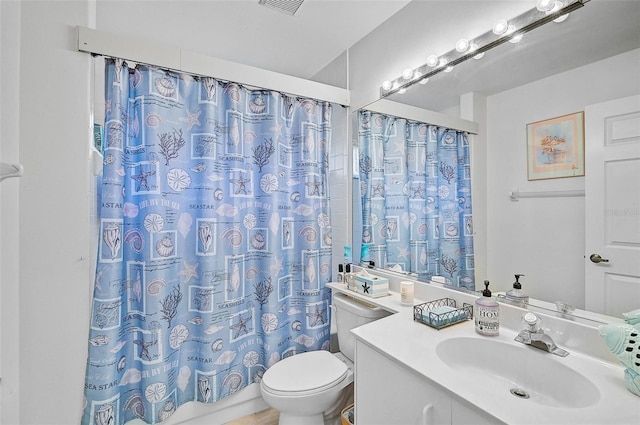 bathroom with toilet, vanity, and a shower with shower curtain