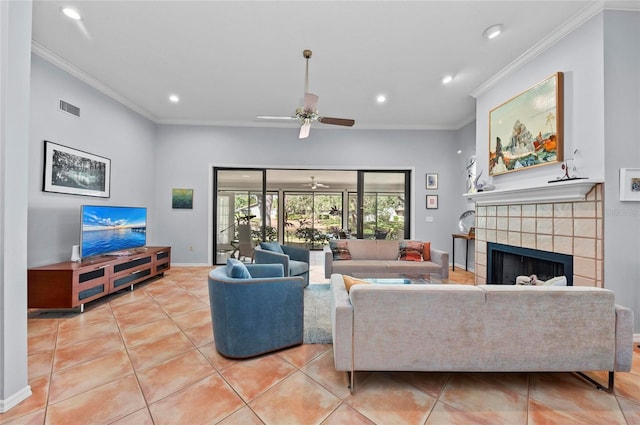 living room with ornamental molding, a tile fireplace, and light tile patterned floors