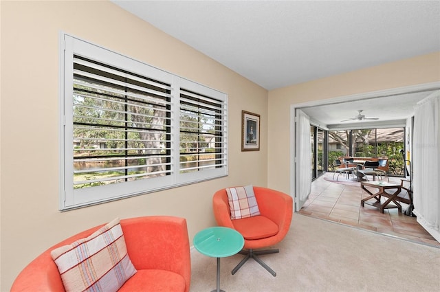 living area with carpet flooring and a textured ceiling