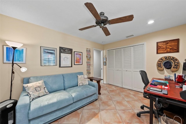 office featuring light tile patterned floors and ceiling fan