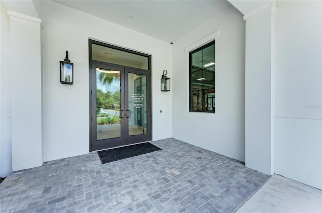 view of exterior entry featuring a patio and french doors