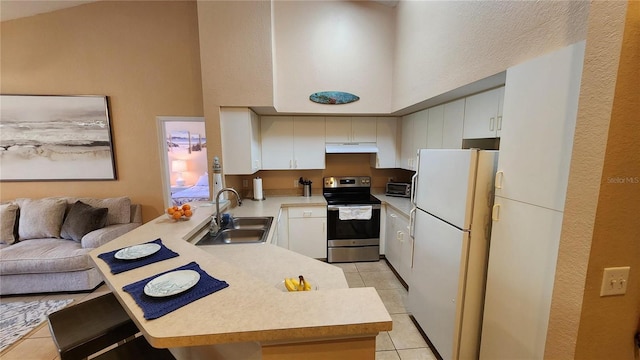 kitchen with stainless steel electric range oven, white cabinetry, sink, white fridge, and kitchen peninsula