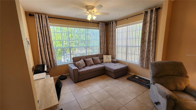 living room with light tile patterned floors, a wealth of natural light, and ceiling fan