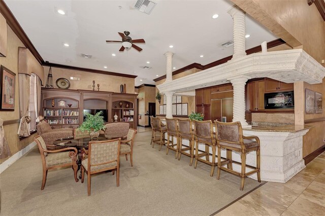 dining room with ornamental molding, decorative columns, and ceiling fan