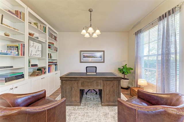 office area with a chandelier