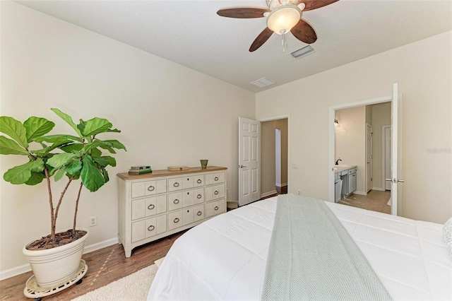 bedroom with sink, wood-type flooring, ceiling fan, and ensuite bathroom