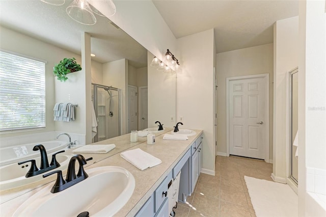 bathroom with tile patterned flooring, vanity, and plus walk in shower