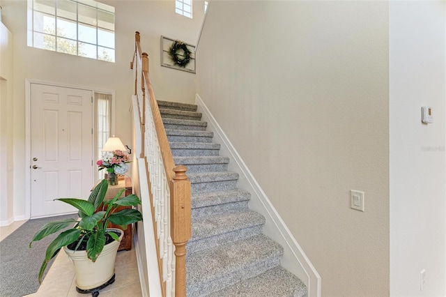 entryway featuring a towering ceiling