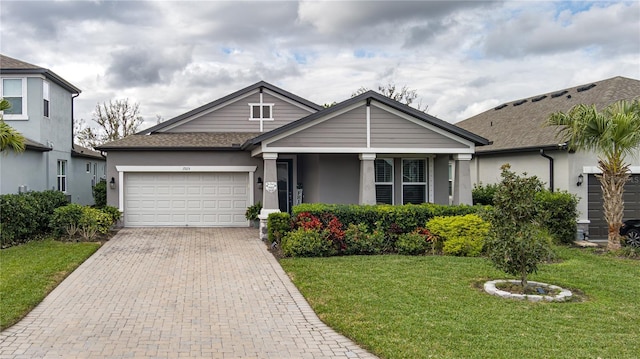 view of front of property with a garage and a front yard