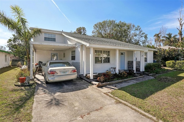 ranch-style house featuring a carport and a front yard