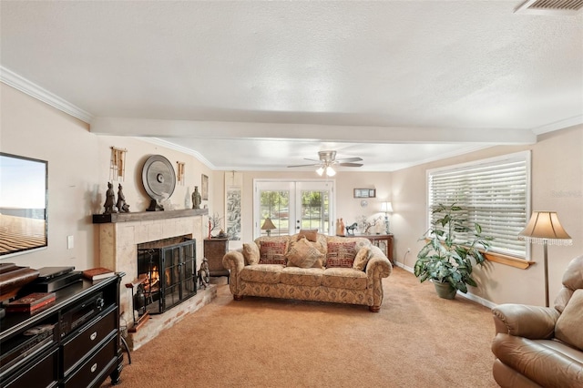 carpeted living room featuring french doors, ceiling fan, ornamental molding, and a textured ceiling