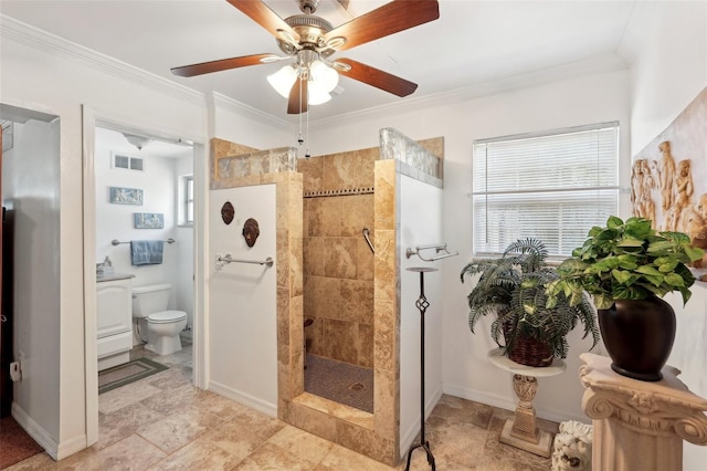 bathroom with crown molding, toilet, and tiled shower