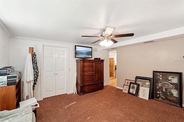 interior space with crown molding, ceiling fan, and a closet