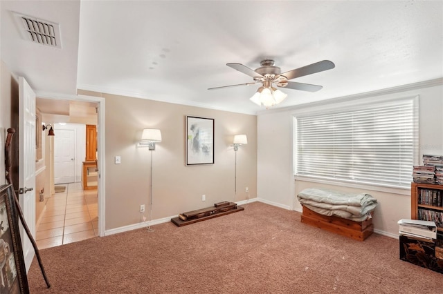 interior space with ceiling fan, ornamental molding, and light carpet