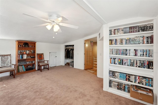 sitting room featuring ceiling fan, lofted ceiling, and light carpet