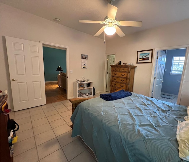 tiled bedroom featuring ceiling fan