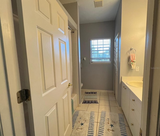 bathroom featuring vanity, tile patterned floors, and toilet