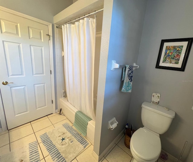 bathroom with toilet, tile patterned flooring, and shower / bath combo with shower curtain